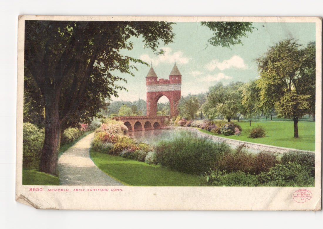 Scenic Memorial Arch in Hartford, Connecticut Park, Early 20th Century Postcard.: A park scene shows the Memorial Arch spanning a body of water, flanked by trees and manicured grounds. A winding pathway in the foreground curves from the left towards the water. The archway, construc