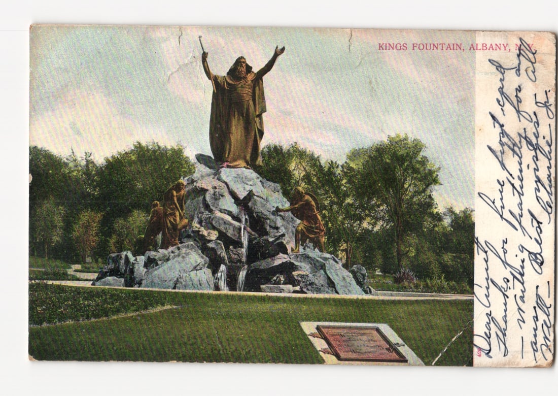 Kings Fountain with Moses Statue in Park, Albany N.Y. Early 20th Century Lithograph Postcard: A central monument depicts Moses holding a staff with his arms raised, standing atop a rocky formation. Two other figures are positioned at the base of the rocks, one appearing to draw water from a po