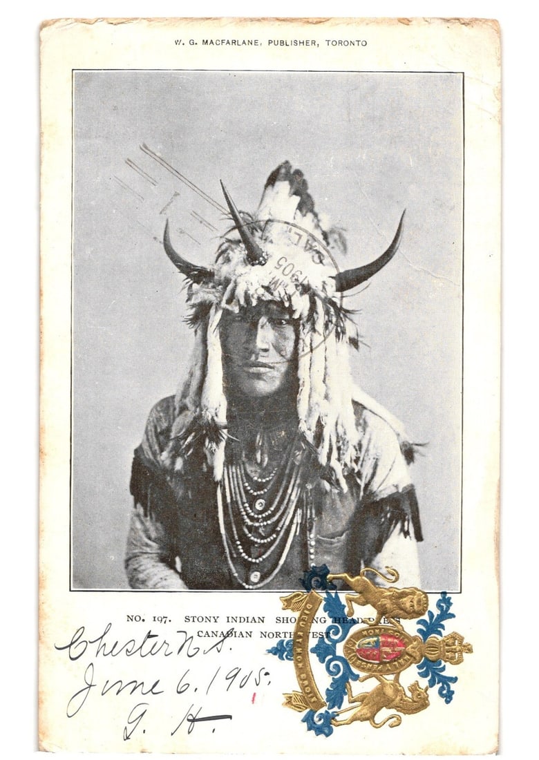 Portrait Postcard of a Stony Indian Chief, Canadian Northwest, 1905, W.G. MacFarlane Publisher: A portrait of an Indigenous man, identified as a Stony Indian, facing forward. He wears an elaborate headdress featuring horns, feathers, and fur, along with multiple necklaces composed of beads. His 