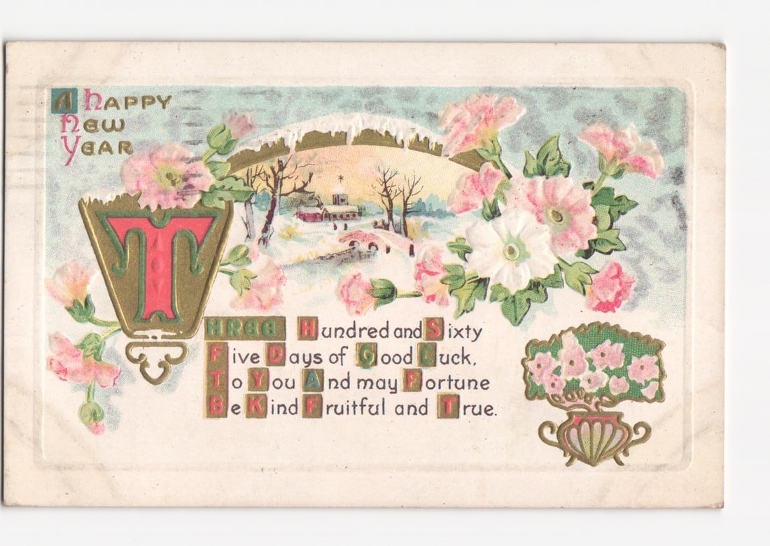 A Happy New Year Greeting Postcard, Winter Landscape with Buildings, Ornate Flowers, circa 1915: A winter landscape depicted under a snow-laden archway, featuring small buildings, bare trees, and a bridge. The scene is bordered by pink and white blossoming flowers with green leaves. An ornate ini