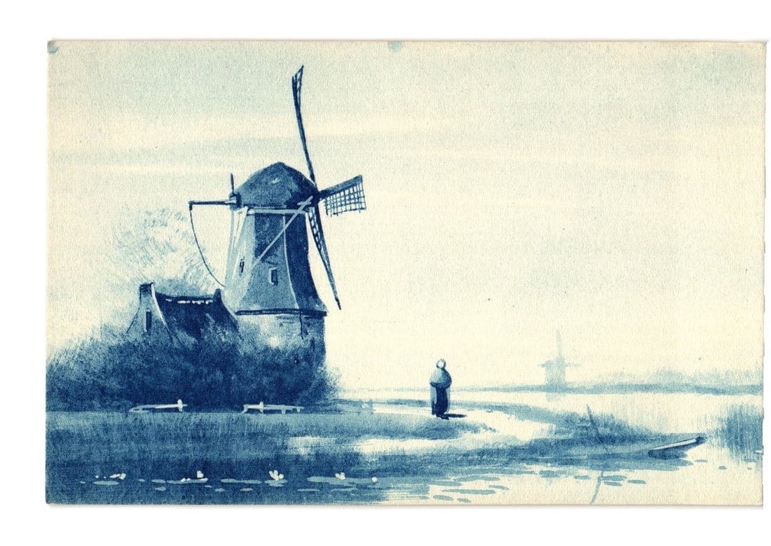 Early 20th-century blue-tone postcard of a Dutch windmill scene with a lone figure and distant mill. (1 of 2)