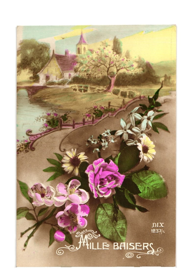 Early 20th Century "A Thousand Kisses" Floral Overlay Rural Landscape Lithograph Postcard: A vibrant floral arrangement is prominently displayed in the foreground, featuring a pink rose, white and yellow daisies, and smaller purple and white blossoms with green foliage. This arrangement ove