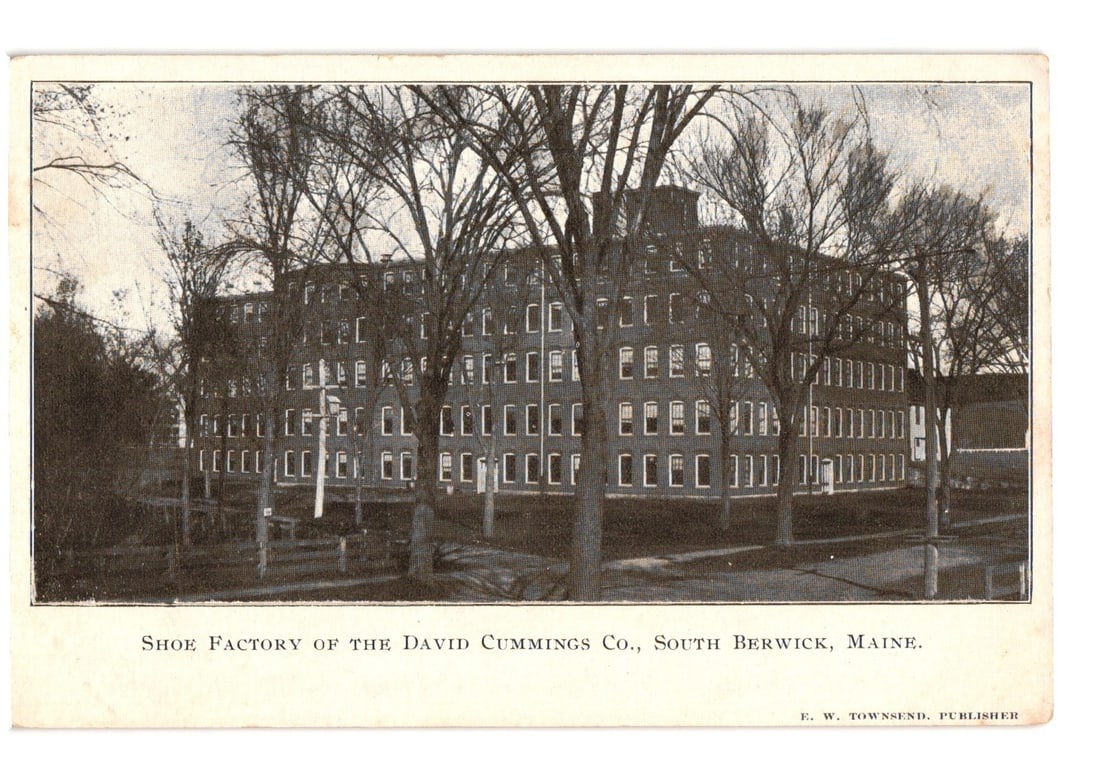 South Berwick, Maine Shoe Factory of David Cummings Co. Monochrome Postcard, Early 20th Century: Monochrome printed photograph depicting the David Cummings Co. Shoe Factory in South Berwick, Maine. The large, multi-story industrial building features numerous windows across its facade. Bare trees 