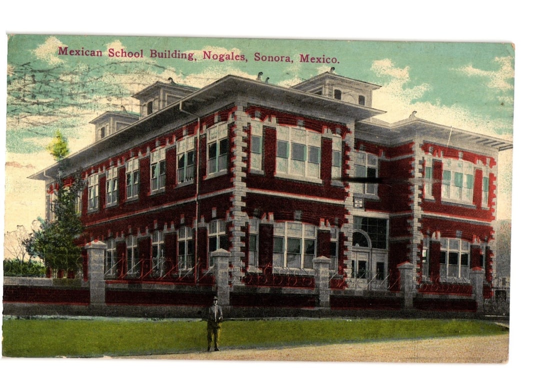 Historic Mexican School Building, Nogales, Sonora, Mexico, circa 1916, Lithograph postcard: A multi-story building featuring red brick walls with white trim and numerous windows is depicted. The architecture suggests a formal institutional purpose, identified as a school building. The struct