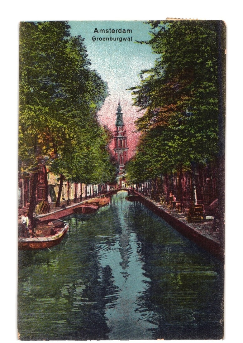 Amsterdam Groenburgwal Canal with Tree-Lined Banks, Netherlands, Early 20th Century Postcard: A canal view in Amsterdam, depicting the Groenburgwal. Tall trees with dense green foliage line both sides of the canal, creating a framing effect. In the distance, a prominent red-brick tower with a 