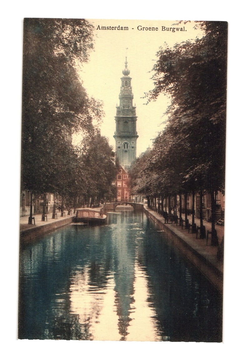 Amsterdam Groene Burgwal Canal and Prominent Tower, Early 1900s European Street Postcard: A view of the Groene Burgwal canal in Amsterdam, looking towards a prominent central tower with an elaborate spire. The canal occupies the foreground, flanked on both sides by dense rows of tall, dark