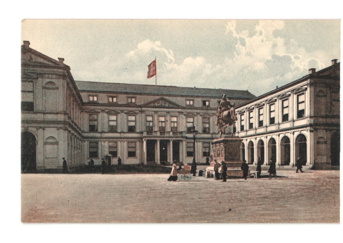 The Hague Royal Palace and Equestrian Statue in Netherlands Courtyard Postcard.: A U-shaped architectural complex encloses a spacious courtyard. The central building features a prominent entrance with a balcony on the second floor, flanked by rectangular windows. The right wing pr