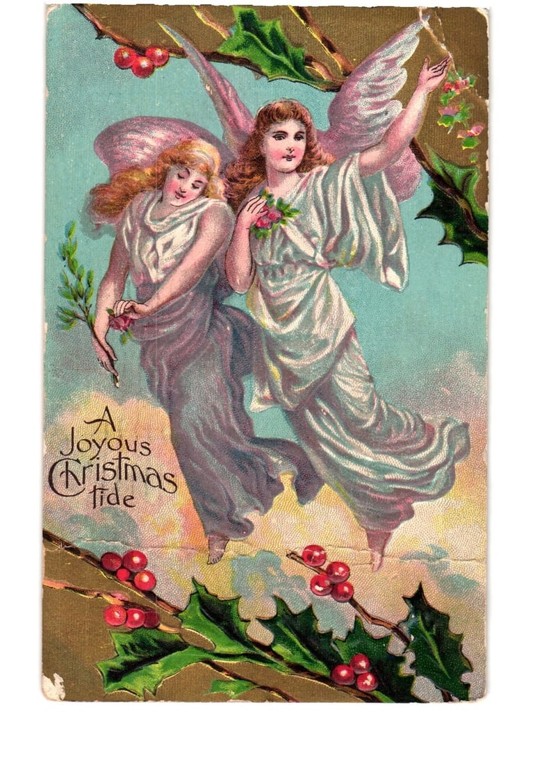 Chromolithograph Postcard of Two Angels with Holly and Berries, 'A Joyous Christmas tide', Early: Two winged figures, resembling angels, float amidst a light blue sky with hints of yellow clouds. The figure on the left has lighter hair and holds a green sprig with small pink flowers. The figure on