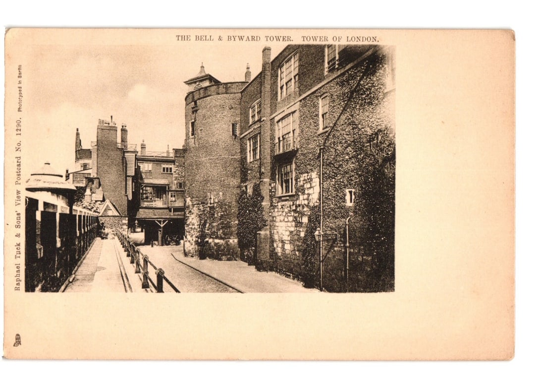 Historic Architectural View: The Bell & Byward Tower, Tower of London, Photographic Postcard: The Bell and Byward Tower in the Tower of London is depicted in a sepia-toned photographic print. The view shows a narrow, paved passage between historic stone buildings, with the rounded Bell Tower v