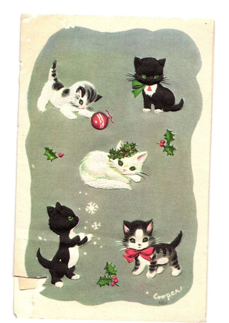 Illustrated Christmas Kittens Holiday Postcard, Adorned with Holly, Ornaments, and Snowflakes: Five illustrated kittens are depicted in various playful poses, set against a grey-green background. A black and white kitten on the top left paws at a red spherical Christmas ornament. A black kitten