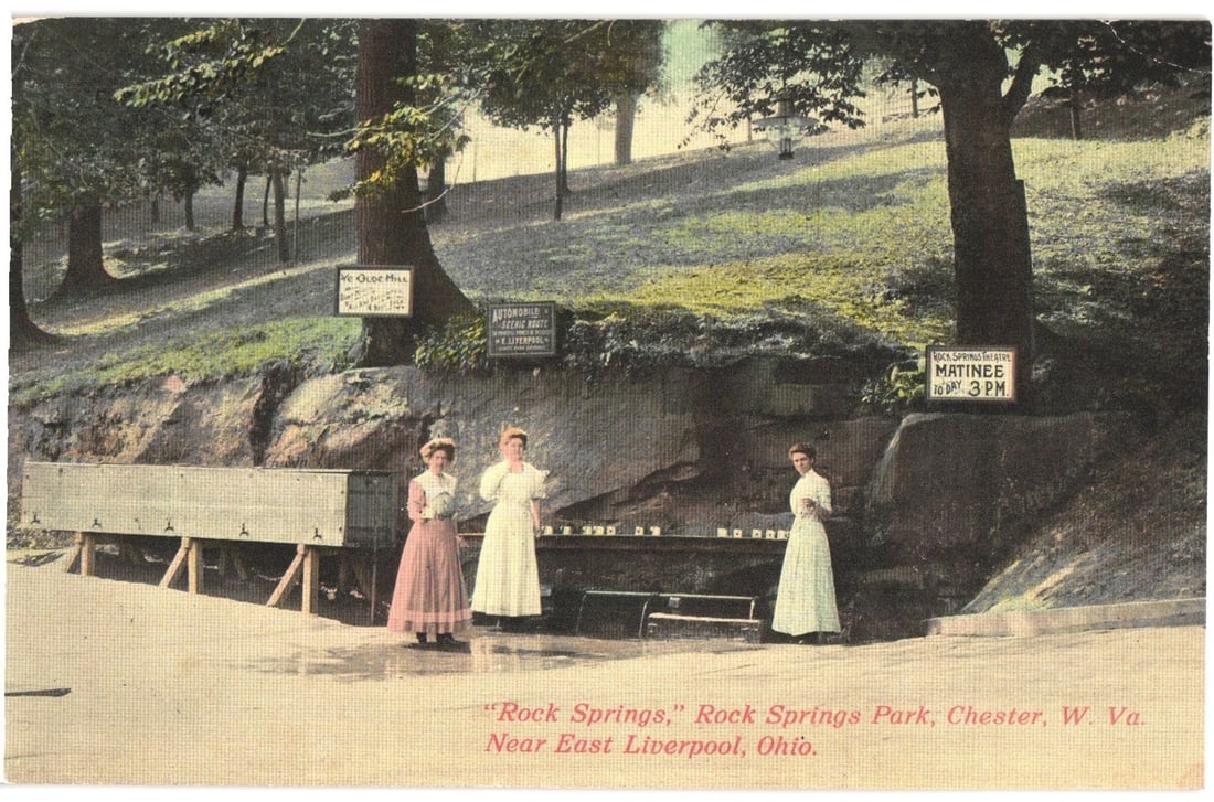 Early 20th-century postcard: Women at Rock Springs Park, Chester, W. Va., near East Liverpool, Ohio.: Three women in early 20th-century attire stand by a water spring structure in Rock Springs Park. The women wear long dresses with high necklines; two are in light-colored gowns, and one wears a darker