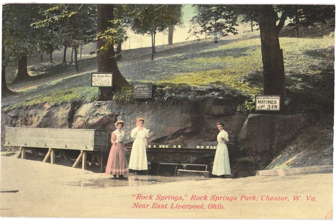 Three Women at Rock Springs Park, Chester, West Virginia, near East Liverpool, Ohio postcard: Three women are depicted at Rock Springs, an outdoor spring facility with a long trough and multiple spouts. The woman on the left wears a patterned skirt and light blouse. The middle woman and the wo