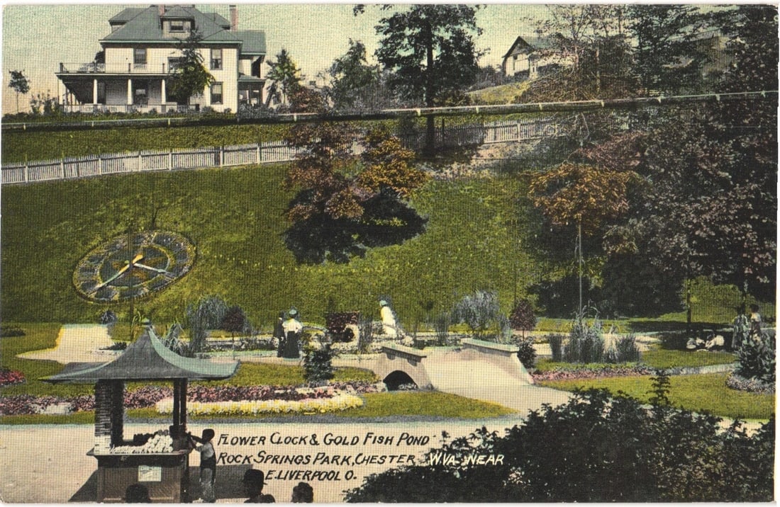 Flower Clock & Gold Fish Pond, Rock Springs Park, Chester, West Virginia, c.1910 postcard: A large landscaped park scene features a prominent flower clock with Roman numerals on a grassy incline in the foreground. Below the clock, a goldfish pond is spanned by a small stone bridge, with a s