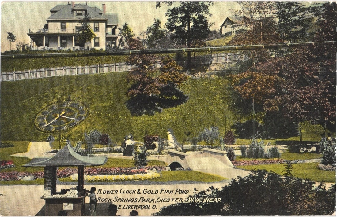 Early 20th Century Rock Springs Park, Chester, WV, Flower Clock & Gold Fish Pond postcard: A panoramic view of Rock Springs Park, showcasing a prominent flower clock and a gold fish pond. The flower clock, featuring large hands, is situated on a verdant, sloping lawn. In the mid-ground, the