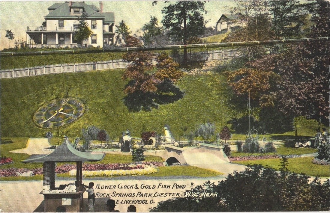 Flower Clock and Gold Fish Pond, Rock Springs Park, Chester, WV, Early 20th Century Postcard: A scenic, elevated view of Rock Springs Park. The foreground features a small pavilion-like structure with a multi-tiered roof, where several figures are gathered. To the right, a goldfish pond is vis