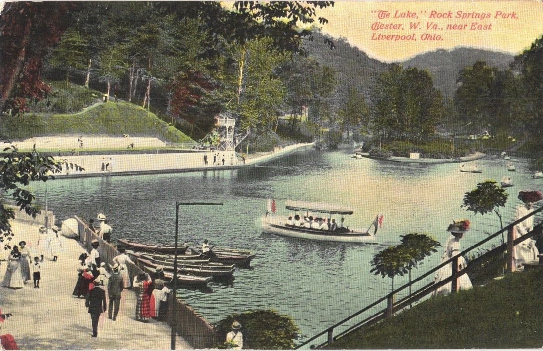 Scenic Lake View at Rock Springs Park, Chester, W. Va., early 20th Century postcard: A chromolithograph depicting a lively lake scene at Rock Springs Park. The foreground features a boardwalk or path with numerous individuals in period attire, including women in long dresses and hats,