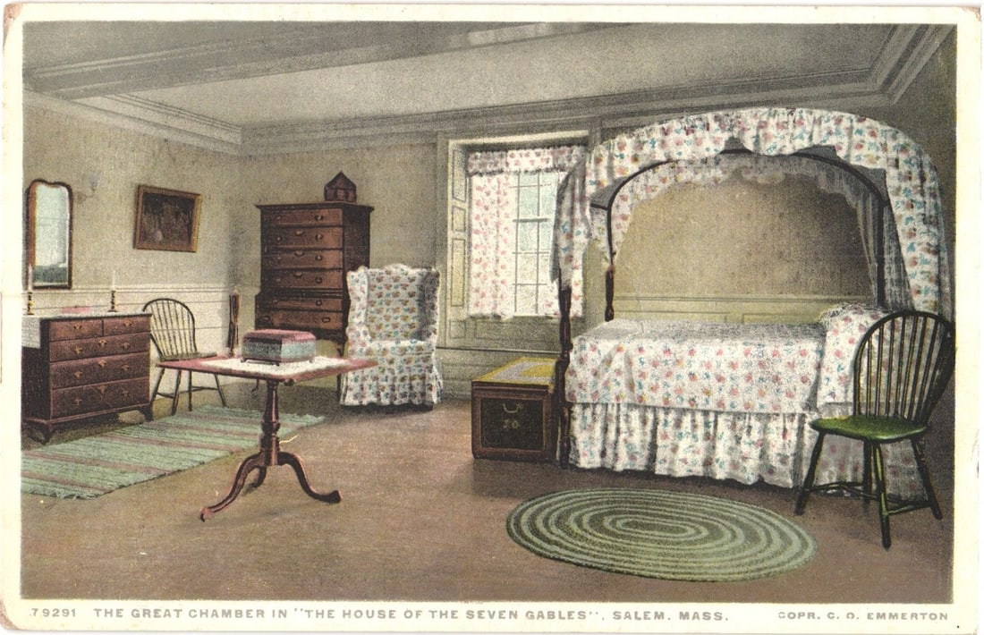Detailed View of The Great Chamber in 'The House of the Seven Gables', Salem, Mass. postcard: An interior view depicts a period bedroom, the Great Chamber. A four-poster bed with a floral patterned canopy, duvet, and skirt occupies the right side of the frame. To its left stands a dark wooden 