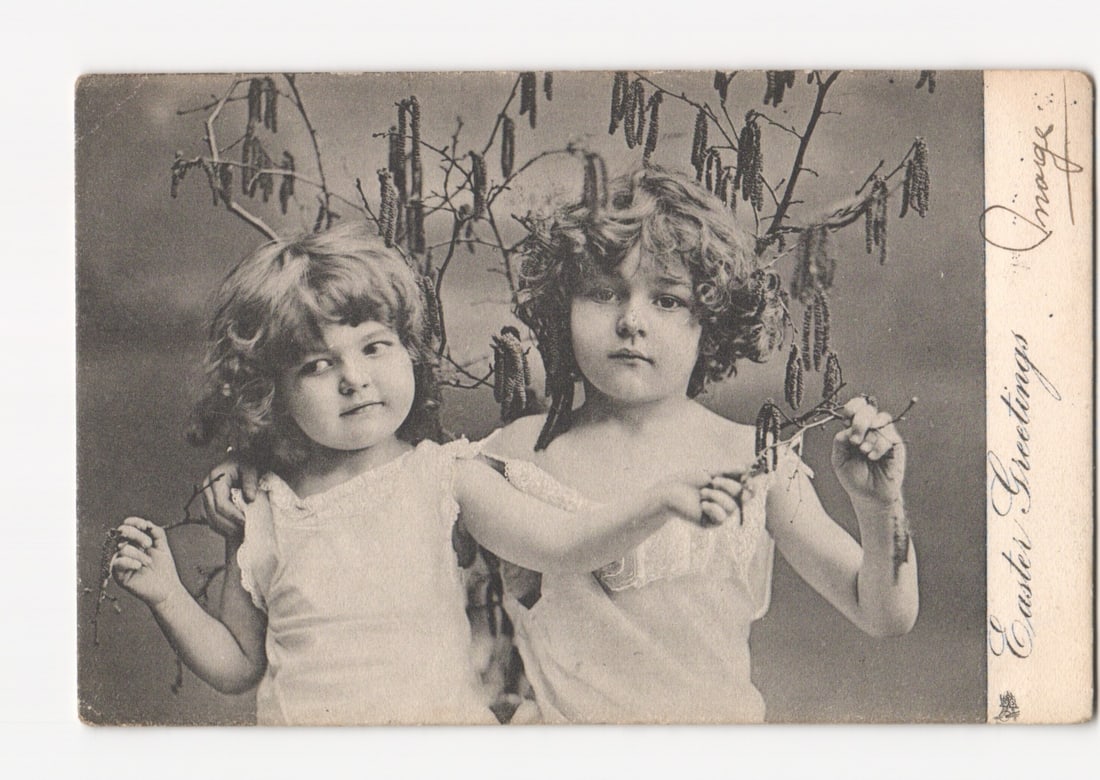 "Easter Greetings" postcard featuring two young girls with catkin branches, early 20th century.: Please review the photos carefully for additional condition details. Note that scans may appear slightly darker or lighter than the item's true appearance, and minor scanning artifacts may be visible.