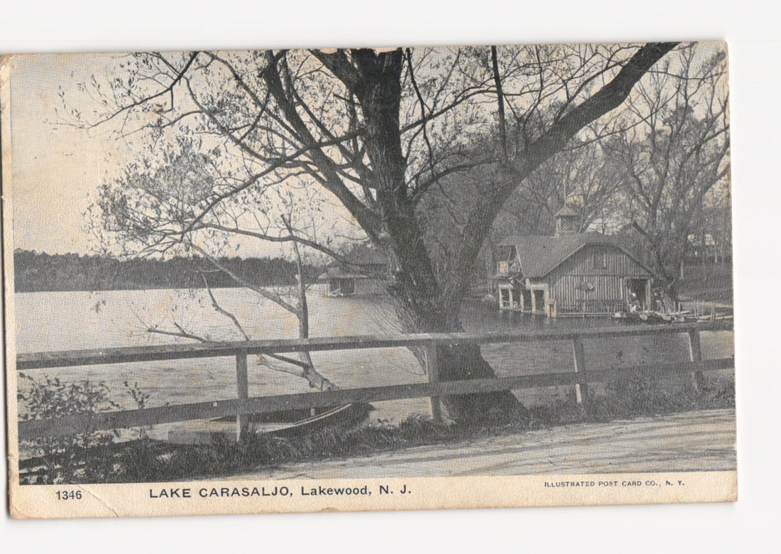 Scenic postcard of Lake Carasaljo, Lakewood, N. J., featuring a boathouse and large tree, c. 1907.: Please review the photos carefully for additional condition details. Note that scans may appear slightly darker or lighter than the item's true appearance, and minor scanning artifacts may be visible.