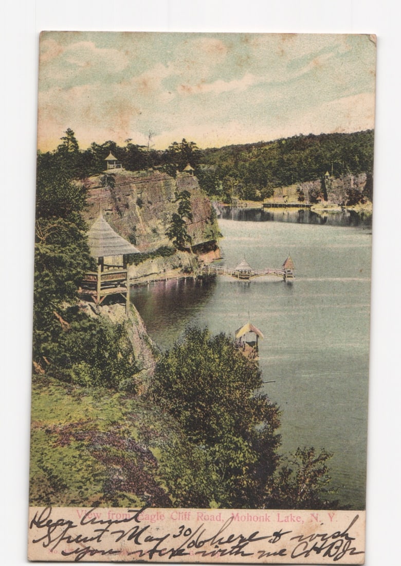 Scenic postcard of Mohonk Lake from Eagle Cliff Road, New York, with lakeside pavilions, circa 1906.: Please review the photos carefully for additional condition details. Note that scans may appear slightly darker or lighter than the item's true appearance, and minor scanning artifacts may be visible.