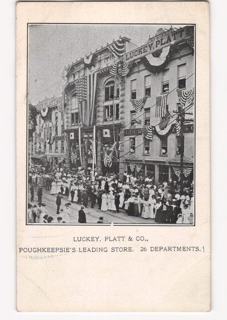 Early 20th Century Postcard of a Large Crowd at Luckey, Platt & Co. in Poughkeepsie: Please review the photos carefully for additional condition details. Note that scans may appear slightly darker or lighter than the item's true appearance, and minor scanning artifacts may be visible.