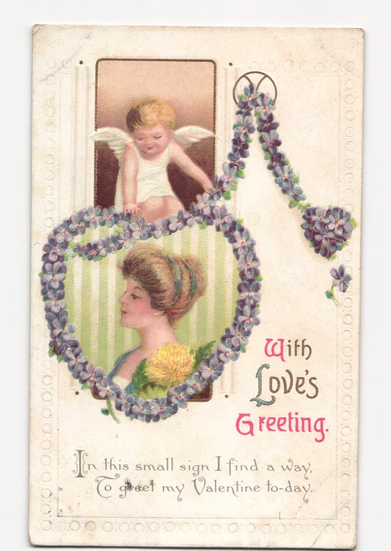 Romantic Valentine postcard: Woman, Cupid, floral heart. Postmarked Orient, 1919, by International: Please review the photos carefully for additional condition details. Note that scans may appear slightly darker or lighter than the item's true appearance, and minor scanning artifacts may be visible.