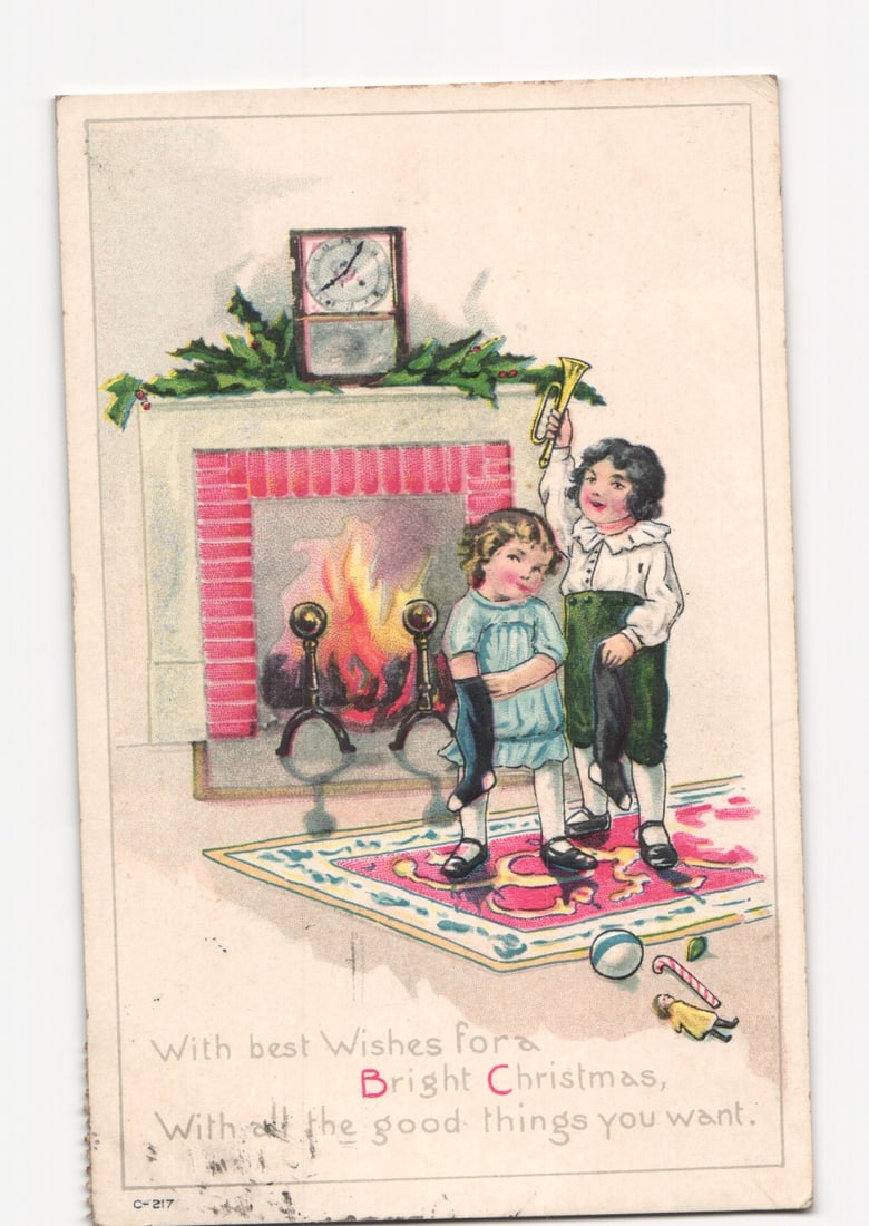 Children with trumpet by a festive fireplace, Christmas scene, 1921 chromolithograph postcard.: Please review the photos carefully for additional condition details. Note that scans may appear slightly darker or lighter than the item's true appearance, and minor scanning artifacts may be visible.