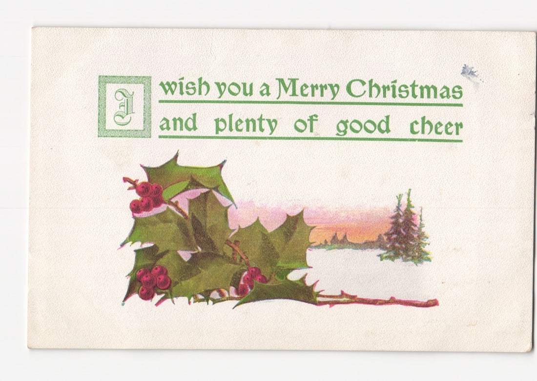 Early 20th Century Christmas Greeting Postcard with Holly Branch and Winter Landscape, 1911: A lithographic illustration depicts a vibrant sprig of holly with green leaves and red berries prominently in the foreground, extending from the lower left. Behind it, a winter landscape features a sm