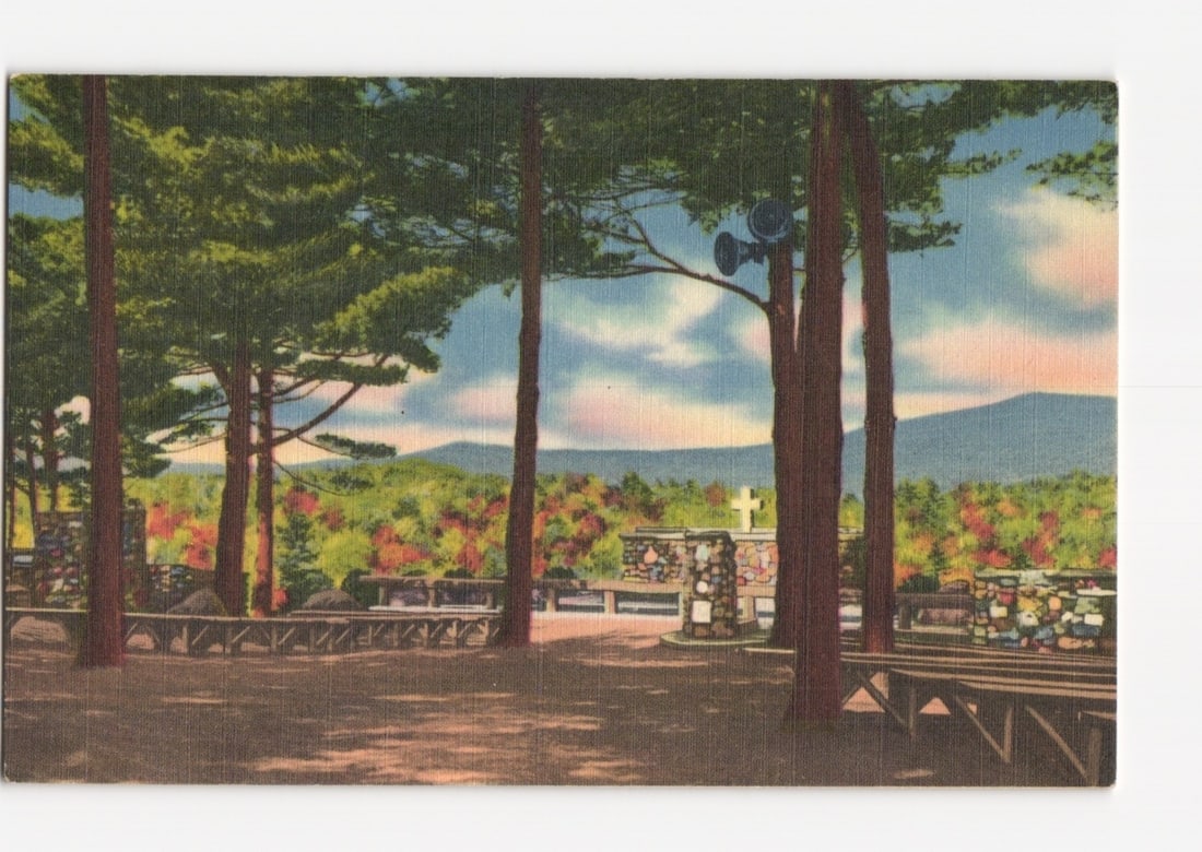 Cathedral of the Pines: The Pulpit, Choir Mound, Organ Pit, Rindge, New Hampshire postcard: A landscape view depicting 'The Pulpit, Choir Mound and Organ Pit' at the Cathedral of the Pines. A central stone structure, appearing as a low wall or pulpit, is framed by tall pine trees. To its lef