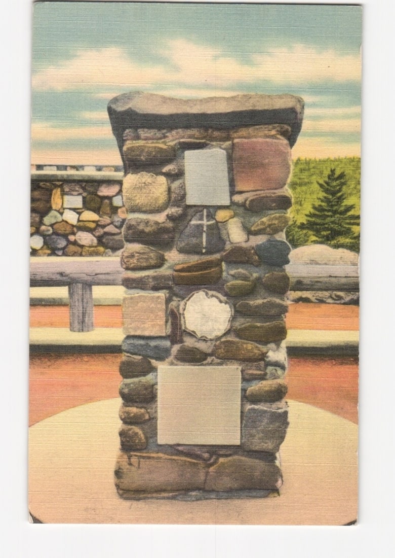 Colorized photo postcard of The Lectern, a stone monument at Cathedral of the Pines, Rindge, New: A tall, rectangular stone monument, identified as The Lectern, stands centrally on a circular base. It is constructed from various sized, irregular natural stones and features several lighter, rectang