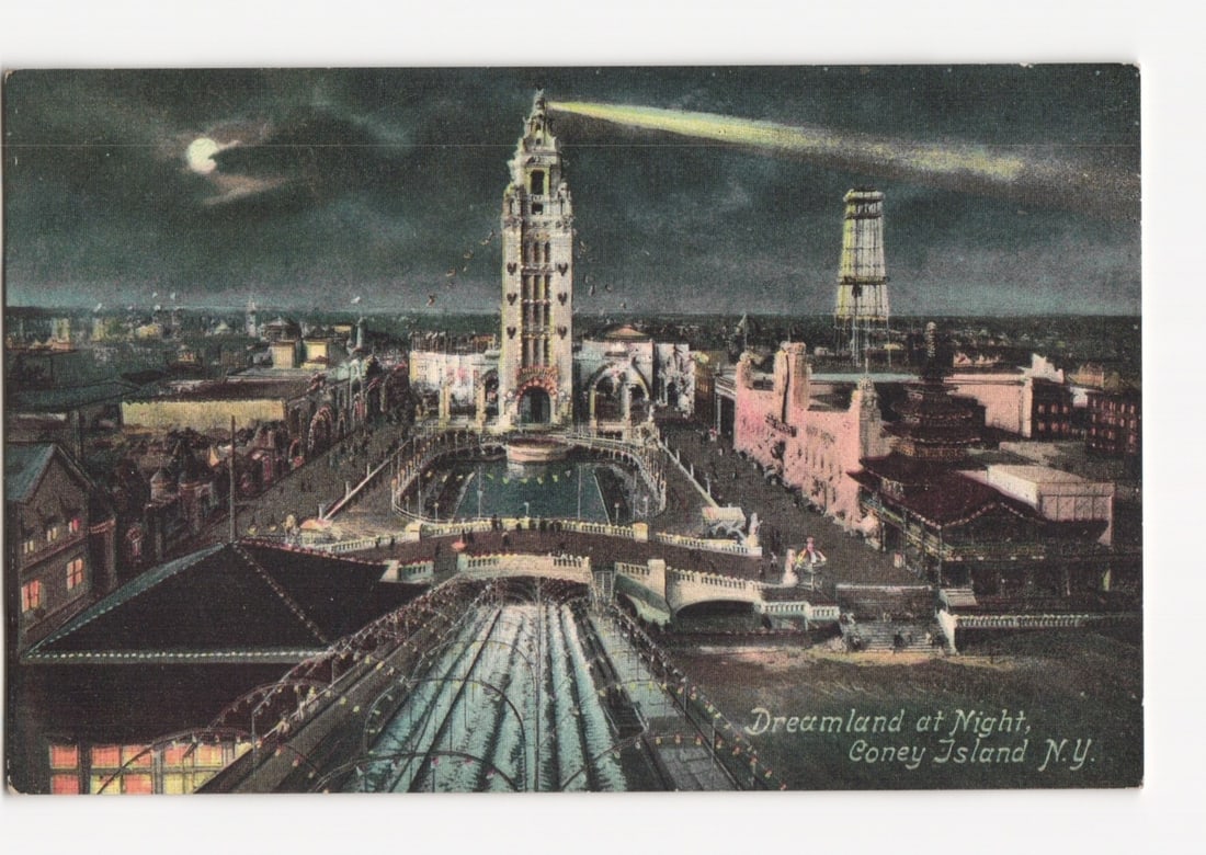 Dreamland at Night, Coney Island, N.Y. illuminated architectural postcard, early 20th century.: A nocturnal aerial view captures Dreamland at Coney Island, New York. A prominent, ornate central tower with a searchlight beam stands tall, alongside a taller, simpler tower. Pathways and structures 
