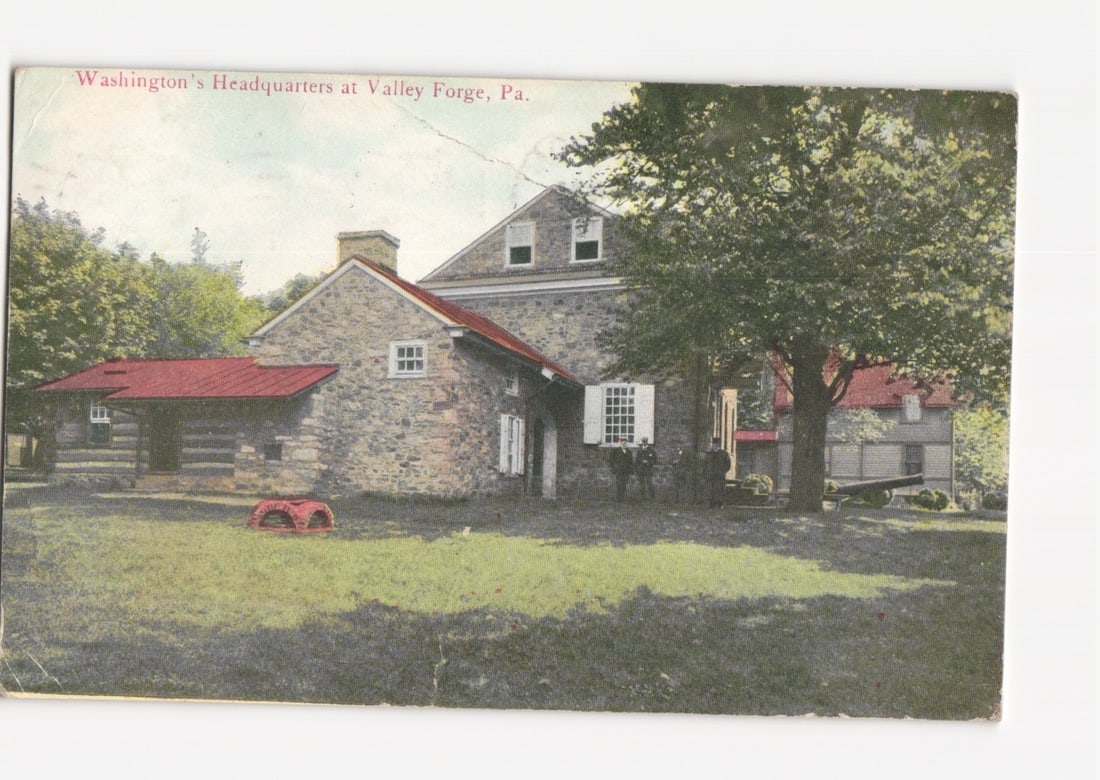 Historic Washington's Headquarters at Valley Forge, Pennsylvania, stone house view postcard, 1910: A two-story stone house with a gabled roof and red-roofed extensions, set amidst a grassy lawn and mature trees. The central stone structure features white-framed windows, one with shutters, and a pro
