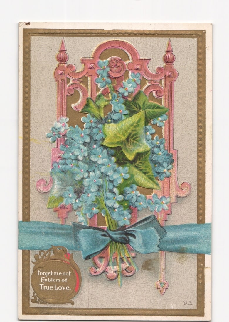Embossed Chromolithograph Postcard: Forget-Me-Not Bouquet in Ornate Frame, Publisher 1910: A chromolithograph postcard featuring a central bouquet of light blue forget-me-not flowers with green leaves, tied with a deep blue ribbon bow. The bouquet is set against an ornate, scrolled, pink an