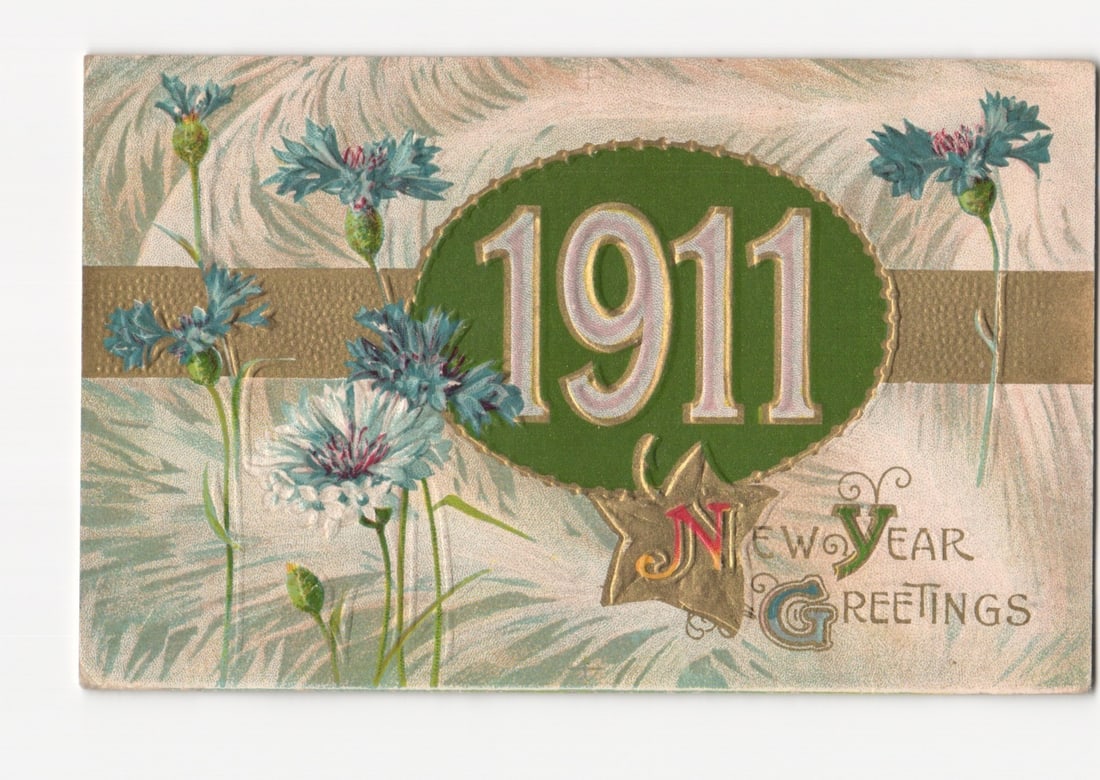 Vintage 1911 New Year Greetings Chromolithograph Postcard, Featuring Stylized Blue Cornflowers: A central green oval features the large numerals "1911" in an ornate, outlined script. A horizontal golden-brown band extends across the card, positioned behind the central oval. Several stylized corn