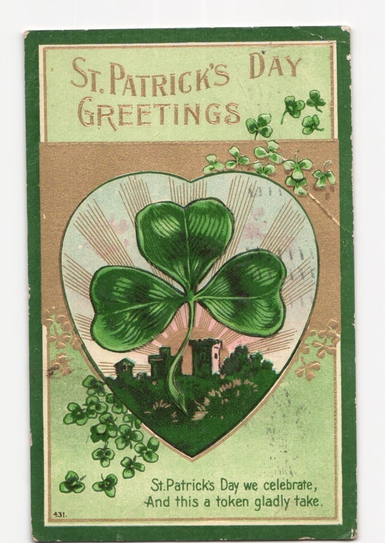 St. Patrick's Day Greetings postcard with central shamrock, castle landscape, and poetic verse,: A large, three-leaf shamrock is centrally framed within a heart-shaped border, below which a stylized landscape of castles and hills is depicted. The composition features green and gold tones, with sc