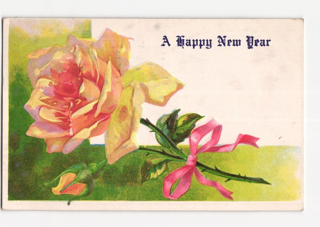 New York Postmarked 1909 Chromolithograph Postcard Depicting a Peach Rose for New Year.: A large peach-colored rose in full bloom, accompanied by a smaller rosebud, is depicted on the left side of the card. A pink satin ribbon is tied around the stem of the rose, trailing towards the righ