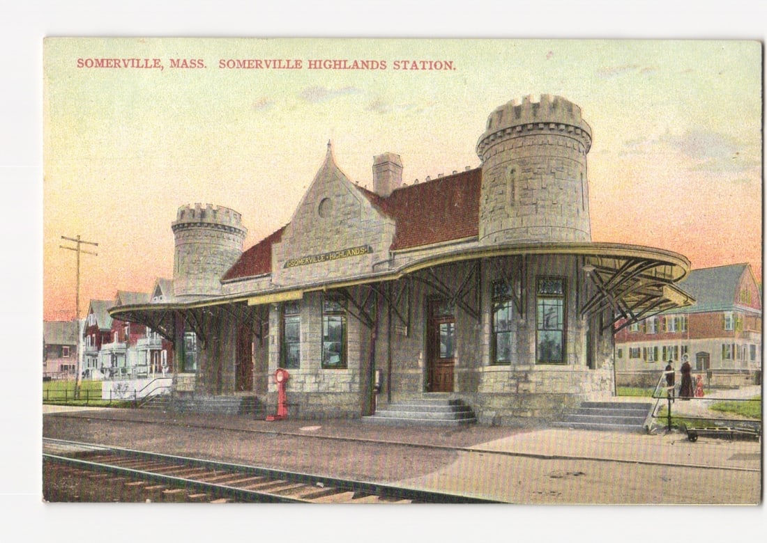 Somerville Highlands Station, Mass. historic railroad architecture postcard, early 1900s.: A view of the Somerville Highlands Station in Somerville, Massachusetts. The station is a substantial stone building featuring two prominent round castellated towers, a gabled roof, and an expansive c
