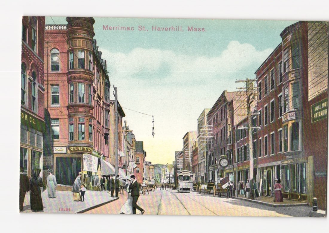 Merrimac Street, Haverhill, Mass. cityscape postcard with streetcar and pedestrians, early 1900s.: A vibrant chromolithograph depicts a bustling street scene along Merrimac Street in Haverhill, Massachusetts. Multi-story brick buildings line both sides of the thoroughfare under a light blue sky wit