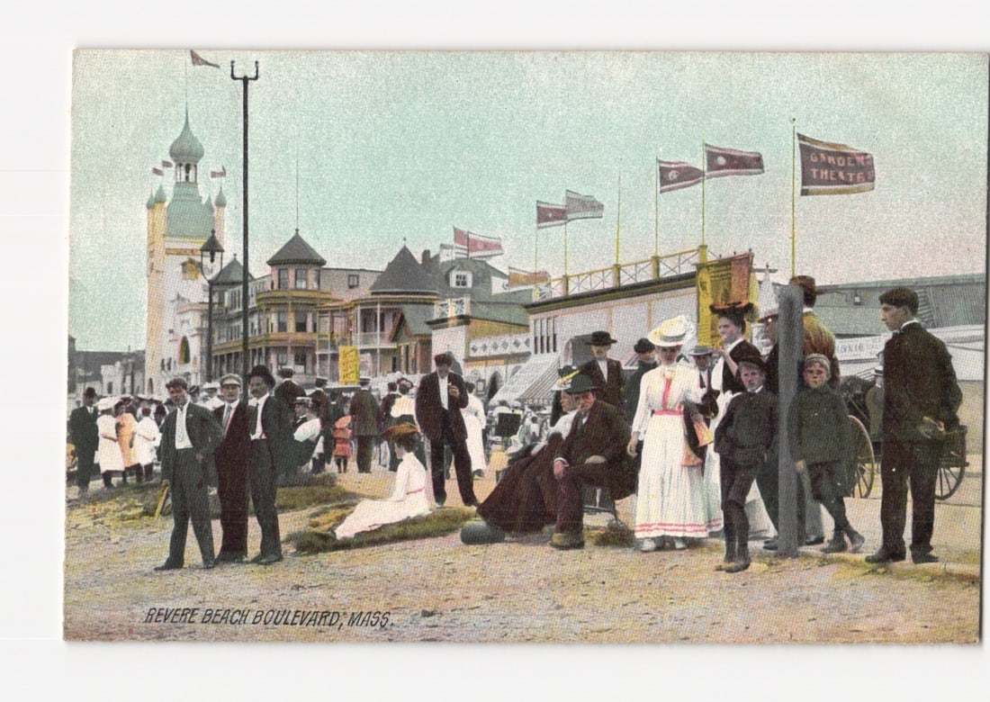 Revere Beach Boulevard, Massachusetts: Lively Early 20th Century Crowd Scene Postcard: A lively street scene on Revere Beach Boulevard, Massachusetts, featuring numerous individuals dressed in early 20th-century fashion. Men in suits and hats, women in long dresses and hats, and childre