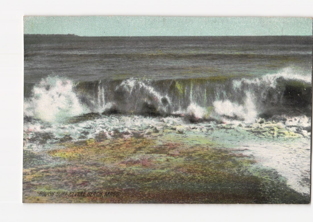 Crashing Rough Surf on Revere Beach, Massachusetts Shore, early 20th century postcard: A vigorous ocean wave crashes onto the shore of Revere Beach, Massachusetts, captured in a horizontal orientation. The wave's crest is white with foam as it breaks, revealing darker water behind it. T