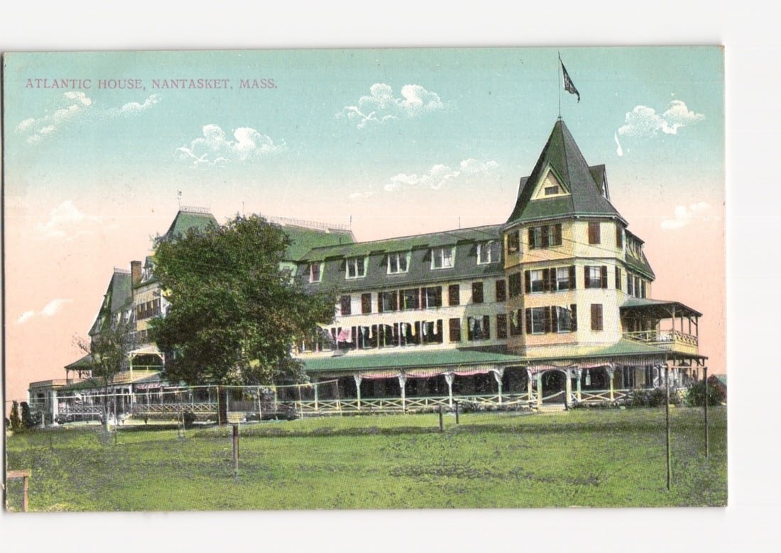 Historic Grand Atlantic House Hotel, Nantasket, Massachusetts, early 20th-century view postcard: A large, multi-story resort hotel, the Atlantic House, dominates the front, viewed from a slightly elevated position across a sweeping lawn. A prominent tree stands to the left. The architecture featu