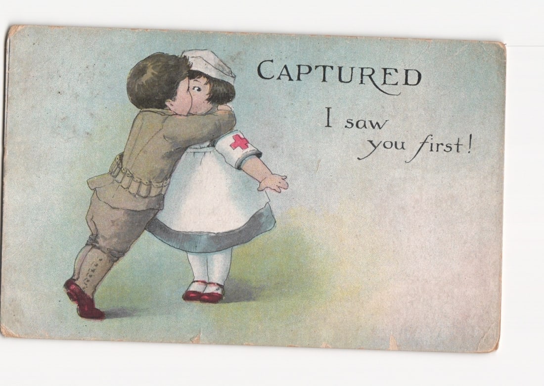 Charming illustrated postcard: Boy in military uniform embraces and kisses a girl nurse, 'Captured'. (1 of 2)