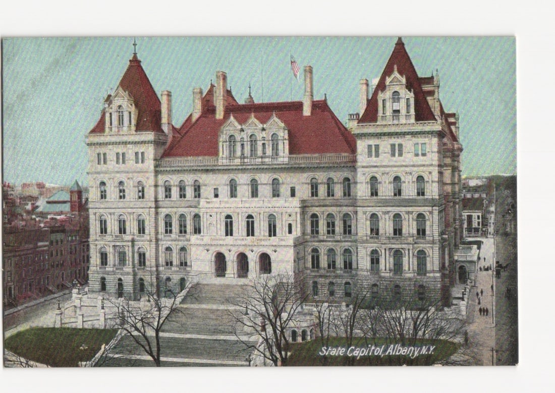 State Capitol Building in Albany, N.Y., depicted on an early 20th century architectural postcard.: A large, ornate government building with a light-colored stone facade and prominent red roofs. The structure features multiple turrets, dormer windows, and a central section with grand entrances and a