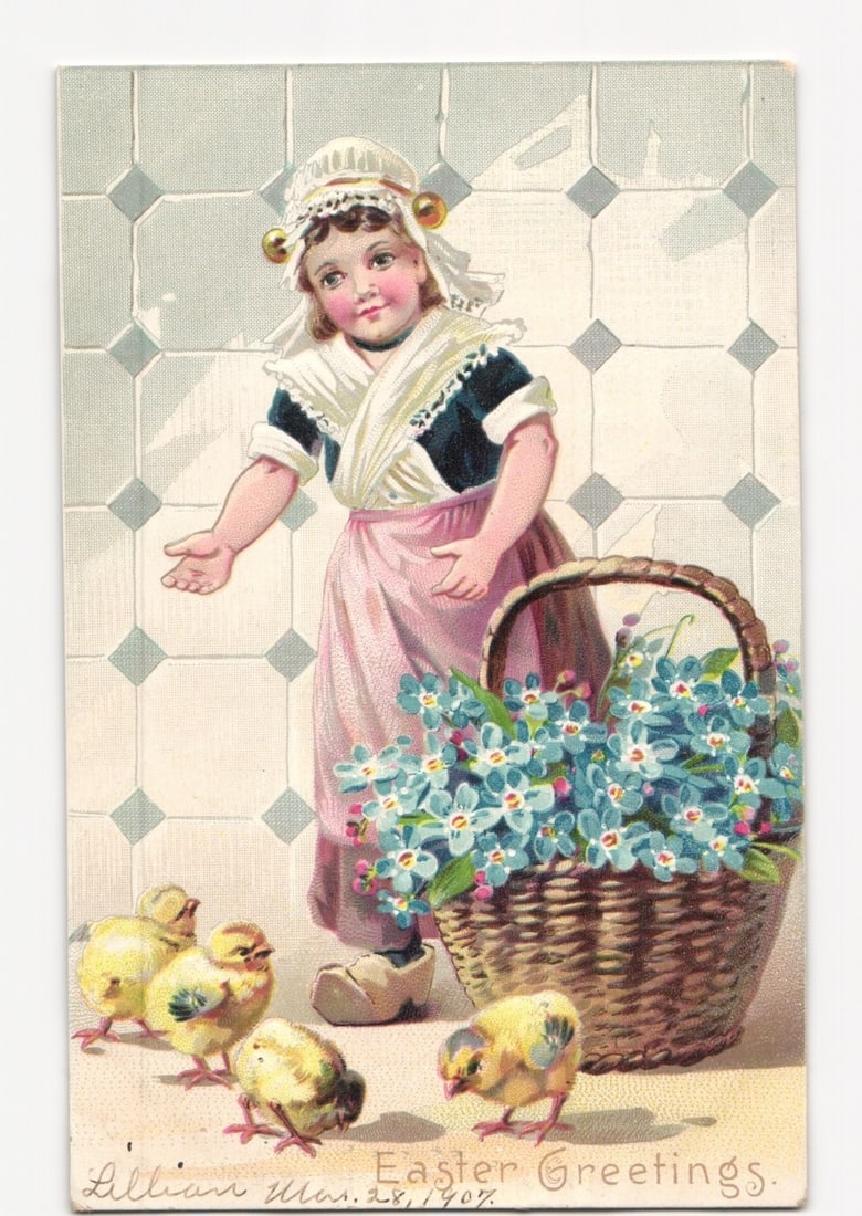 Vintage Chromolithograph Postcard: Dutch Child with Chicks and Basket of Flowers, 1907: A young child in traditional Dutch attire stands before a tiled background, her left hand extended. She wears a white bonnet with gold disc ornaments, a white kerchief, a dark bodice, a pink apron ove