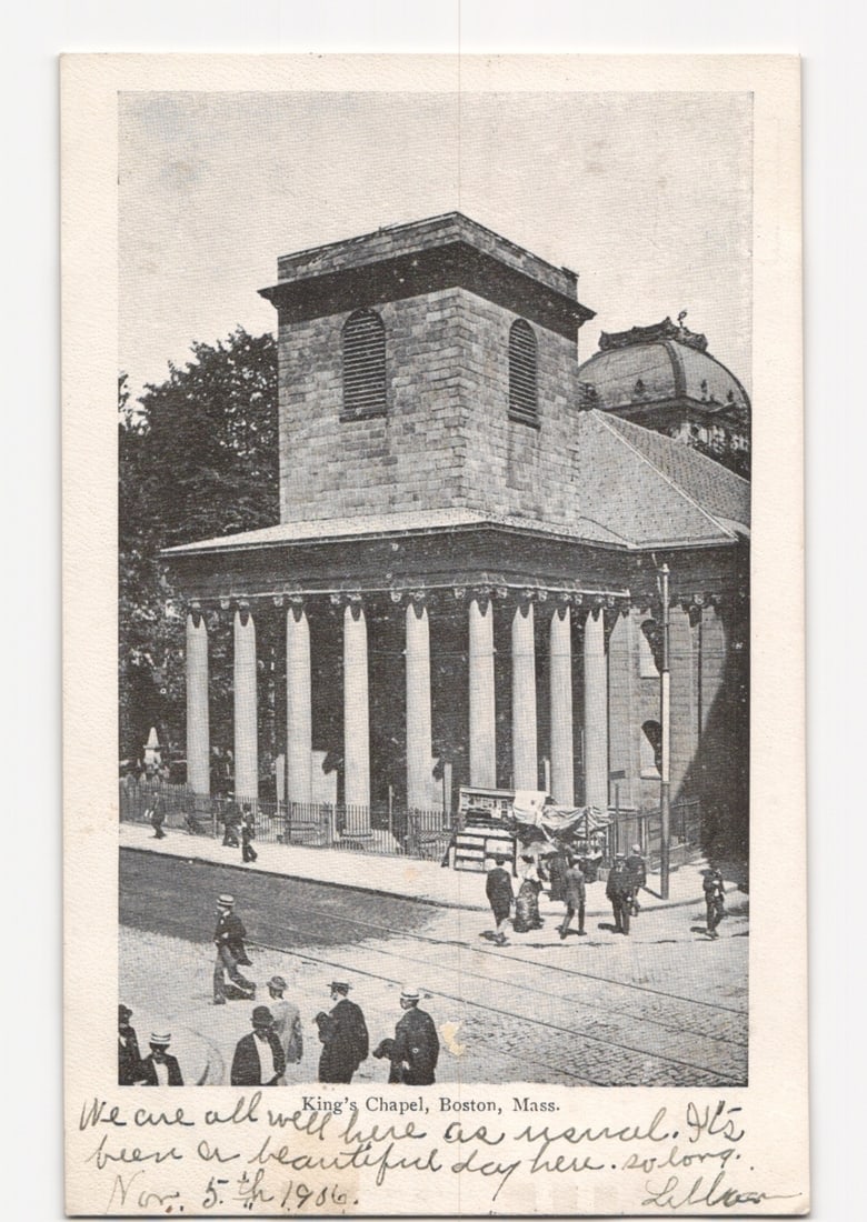 King's Chapel, Boston, Mass., early 20th-century street scene photographic postcard.: King's Chapel in Boston, Massachusetts, is depicted from a street-level perspective, angled to show its front and side facades. The prominent building features a classical portico with multiple column