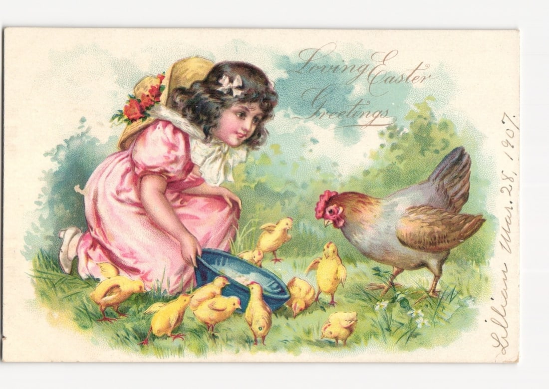 Easter Greetings postcard: Young girl in pink dress feeding chicks, early 20th century: A young girl in a pink dress and a straw hat adorned with floral accents kneels in a grassy field, holding a blue bowl of feed. She is looking down at a group of yellow chicks gathered around the bowl