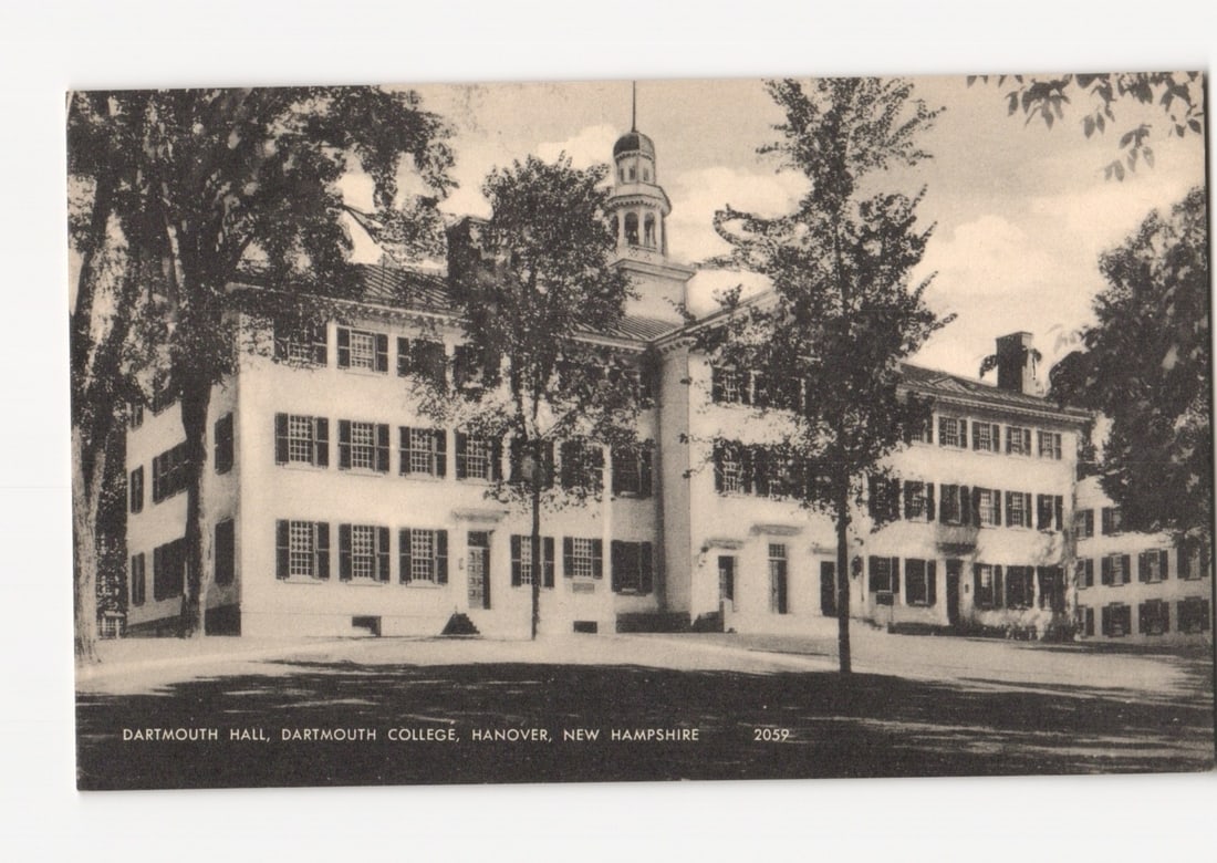 Photographic postcard depicting Dartmouth Hall, Dartmouth College, Hanover, New Hampshire: A large, multi-story institutional building, identified as Dartmouth Hall, stands prominently amidst trees on a college campus. The building features a symmetrical facade with numerous windows, a cent