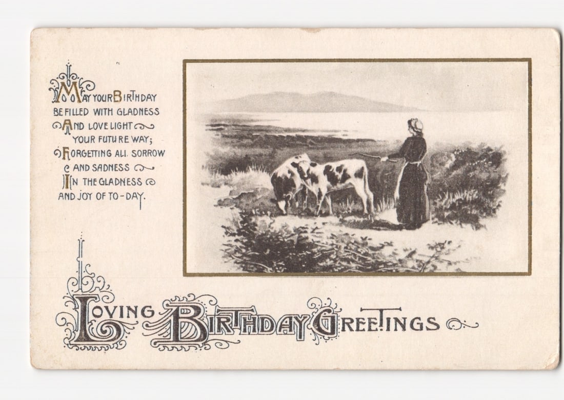 Woman with Two Cows in Pastoral Landscape, Early 20th Century Illustrated Birthday Postcard.: An illustrated birthday postcard featuring a pastoral scene. The central image depicts a woman in a long, dark dress, standing with two cows in a landscape that includes water and distant hills. The w