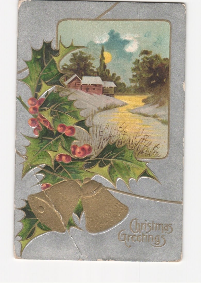 Embossed Christmas postcard with holly branches, gold bells, and a snowy winter landscape.: An embossed chromolithograph postcard featuring a winter landscape scene framed by holly branches and golden bells. The central rectangular vignette depicts snow-covered ground, a winding river, and s