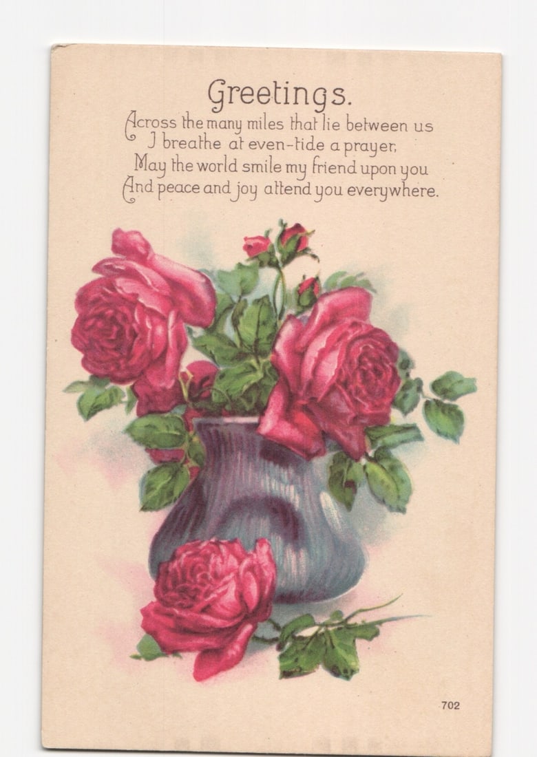 Color-printed Greetings postcard depicting a still life arrangement of vibrant red roses in a dark: A chromolithograph postcard features a still life with a bouquet of red and pink roses and green foliage in a dark blue, textured vase. An additional rose lies near the base of the vase. Above the flo